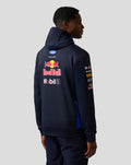 Back view of a model wearing a navy Red Bull Racing Teamline hoodie with large sponsor logos.