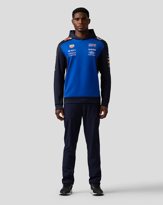 Male model wearing Oracle Red Bull Racing Teamline Overhead Hoodie in night sky blue with navy sleeves hood up.