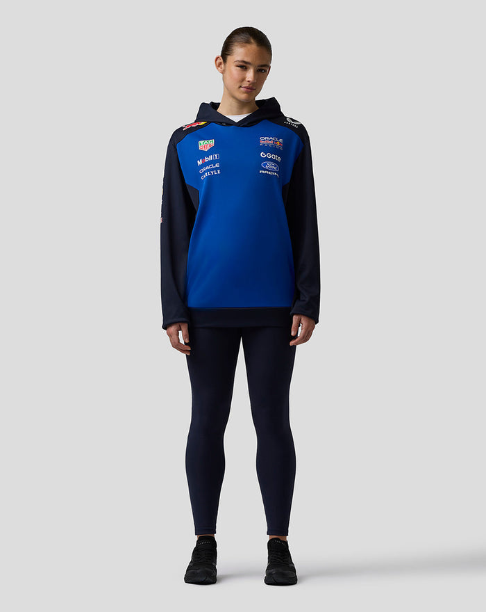 Female model in navy sleeve Oracle Red Bull Racing Teamline Overhead Hoodie with blue center panel and hood.