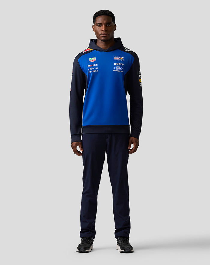 Male model wearing Oracle Red Bull Racing Teamline Overhead Hoodie in night sky blue with navy sleeves hood up.