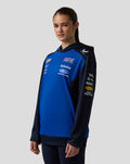 Female model wearing Oracle Red Bull Racing Teamline Overhead Hoodie in night sky blue with sponsor logos on chest and sleeve
