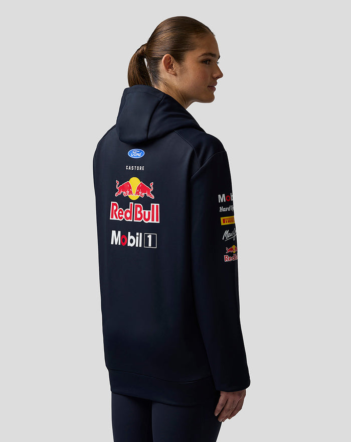 Side-back view of navy Teamline hoodie on a female model with hood up and Red Bull branding on the back
