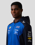 Portrait of a woman in Night Sky blue Oracle Red Bull Racing Teamline hoodie with navy sleeves and logos.