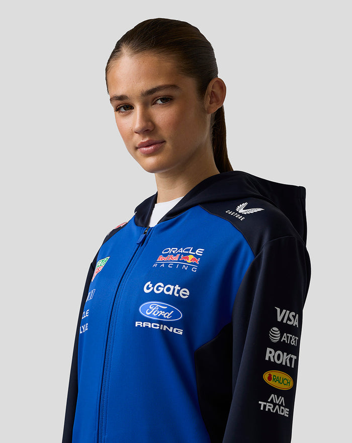 Female model wearing the Oracle Red Bull Racing Teamline full zip hoodie in night sky and navy with chest logos and side pockets