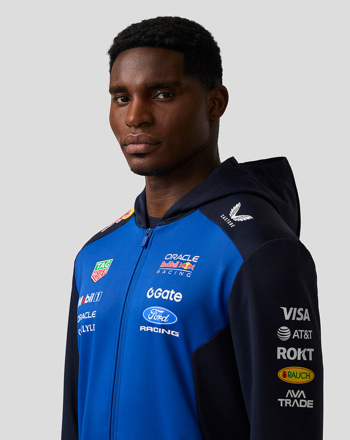 Portrait of a woman in Night Sky blue Oracle Red Bull Racing Teamline hoodie with navy sleeves and logos.