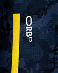 Close-up of navy camouflage fabric with a bright yellow vertical stripe and partial Red Bull lettering on the polo back.
