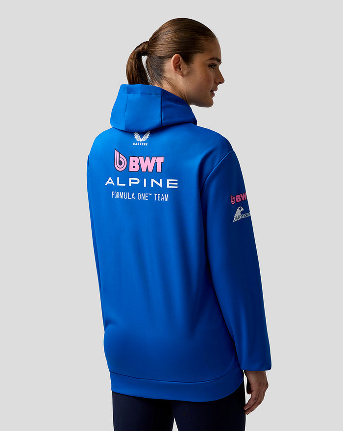 Back view of blue BWT Alpine Formula One Team hoodie with a large logo on the back worn by a model.