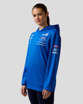 Blue BWT Alpine Formula One Team hoodie worn by a model showing chest and sleeve logos and a front kangaroo pocket