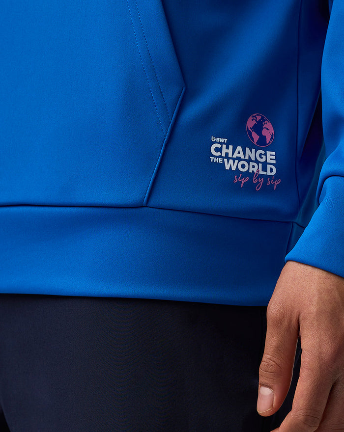 Close up of the blue hoodie lower front with BWT Change the World graphic near the pocket