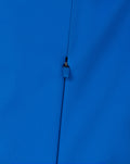 Close up of the blue zipper pull and fabric texture on the BWT Alpine jacket