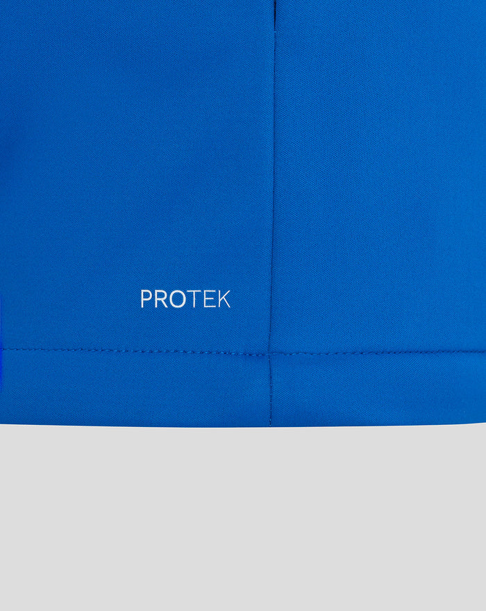 Blue BWT Alpine jacket close up showing PROTEK wordmark at the lower hem.