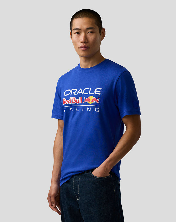 Model wearing blue Oracle Red Bull Racing unisex logo t shirt with chest graphic and left sleeve badge.