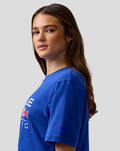 Side profile of a woman in a blue Oracle Red Bull Racing T shirt with chest print