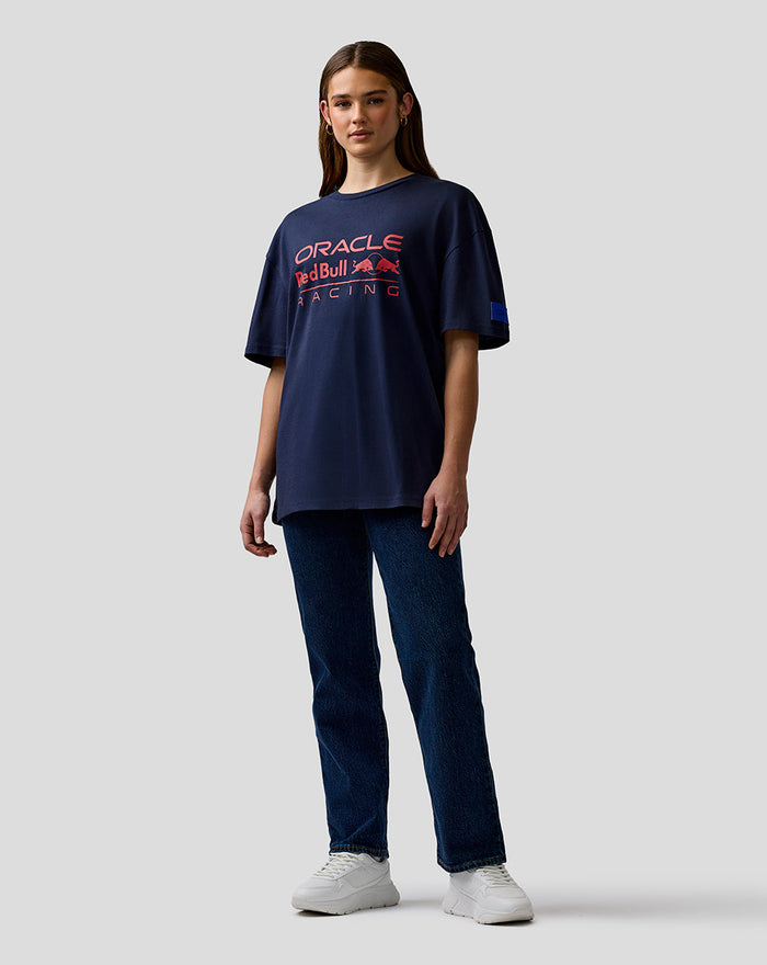 Woman wearing Night Sky navy Oracle Red Bull Racing T-shirt with large chest logo and left sleeve badge.