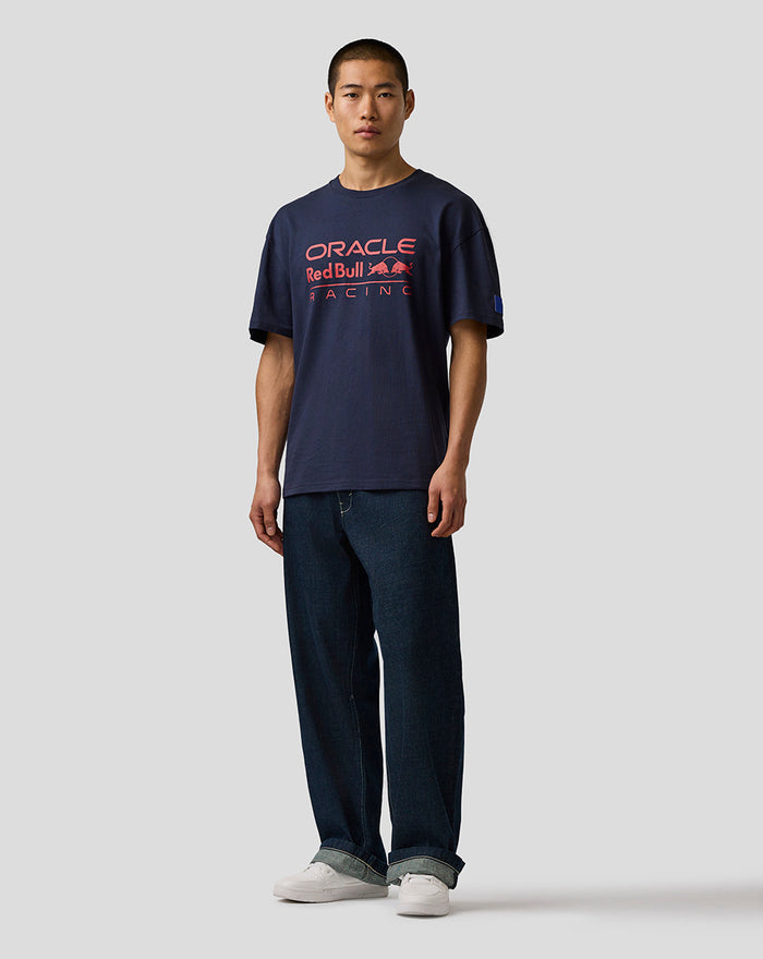 Man wearing Night Sky navy Oracle Red Bull Racing T-shirt with large front logo and left sleeve badge.