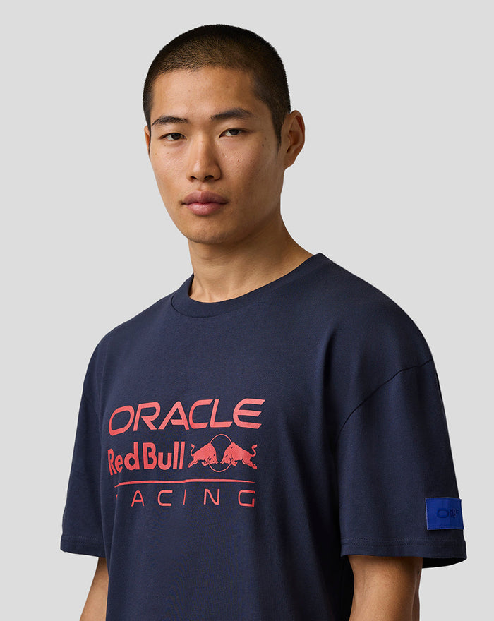 Man wearing navy Oracle Red Bull Racing relaxed fit logo T-shirt with bold chest print and sleeve badge.