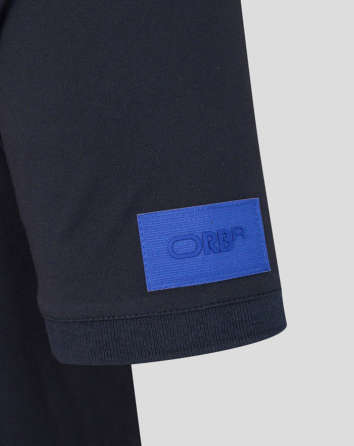Close-up of sleeve hem showing a blue ORBR patch on the polo sleeve