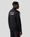 Back view of a model in a black Haas Team Quarter Zip Midlayer with Haas and Toyota Gazoo Racing logos and a USA flag at the hem