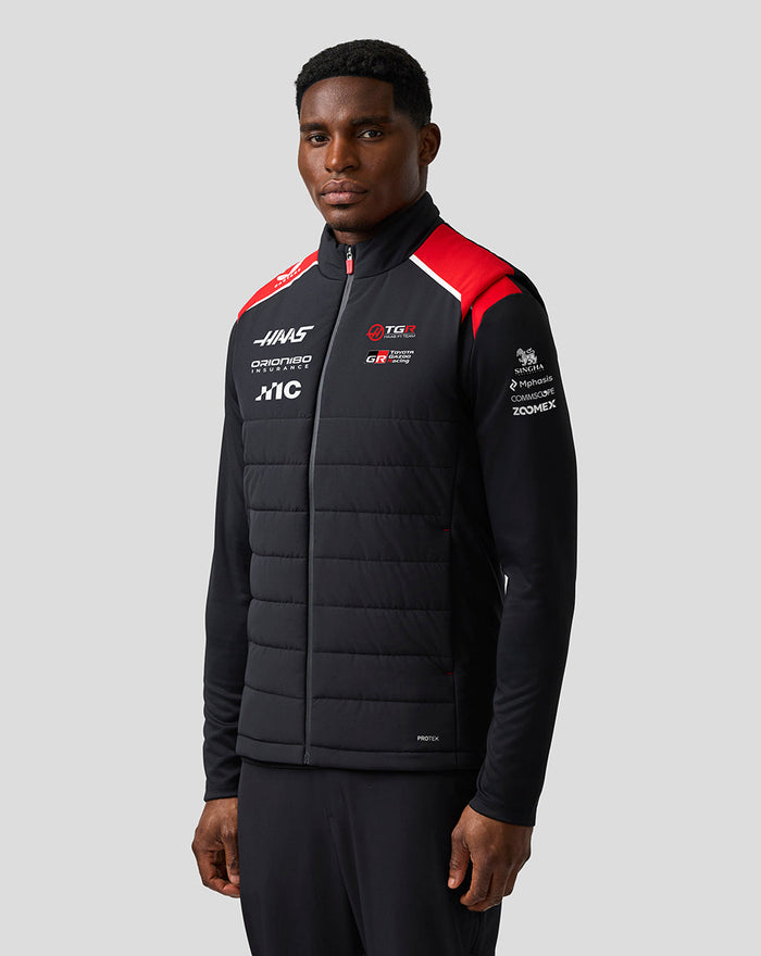 Three-quarter front view of a model in the Haas Team Unisex Gilet with quilted panels and sponsor logos