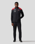 Man modeling the Official Haas Team Unisex Gilet with zip front red shoulder accents and sponsor logos on the chest