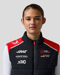 Front view of a female model wearing Official Haas Team Unisex Gilet with red shoulders and race team logos