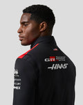 Back view of a male model in the Haas Team Gilet featuring sponsor logos and a US flag patch