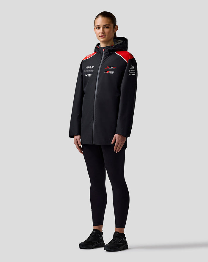 Model wearing Official Haas Team water resistant jacket with hood, full front zip and sponsor logos