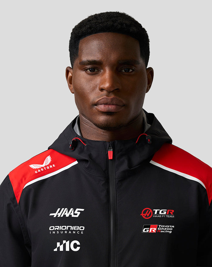 Close-up of Haas Team jacket chest area with logos and red shoulder accents