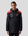 Female model wearing Haas Team Water Resistant Jacket with hood and branded chest logos.