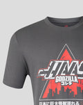 Close-up of the front graphic on the dark gray Godzilla Tokyo Haas T shirt showing bold lettering and a red triangle