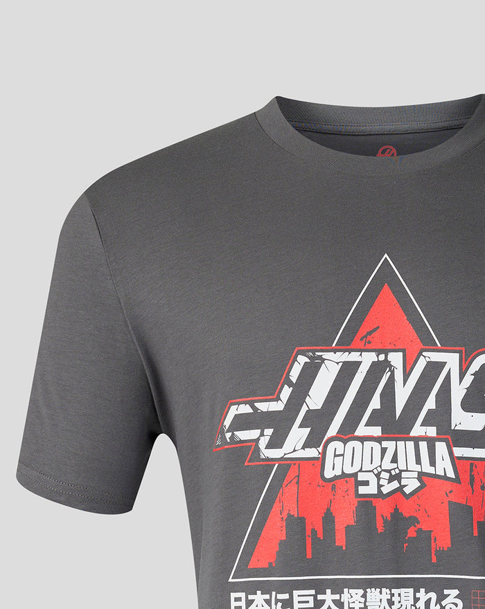 Close-up of the front graphic on the dark gray Godzilla Tokyo Haas T shirt showing bold lettering and a red triangle