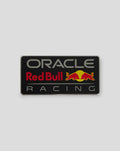 Night Sky pin badge with Red Bull Racing logo on a black backing beside its packaging