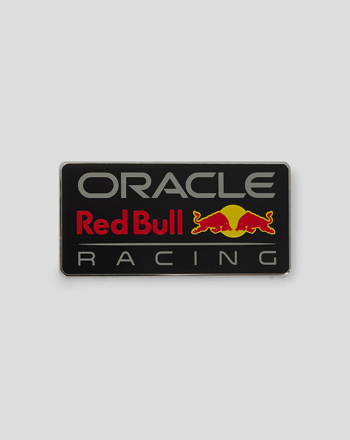 Night Sky pin badge with Red Bull Racing logo on a black backing beside its packaging