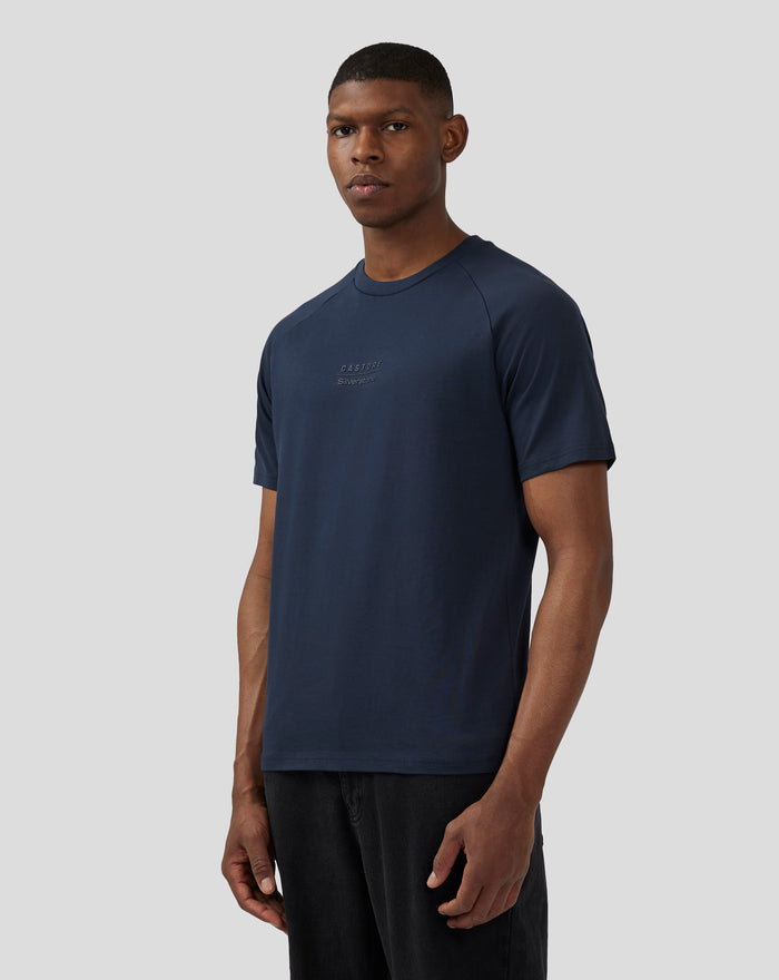 Male model wearing navy unisex Silverstone x Castore short sleeve T shirt with a tonal chest logo.