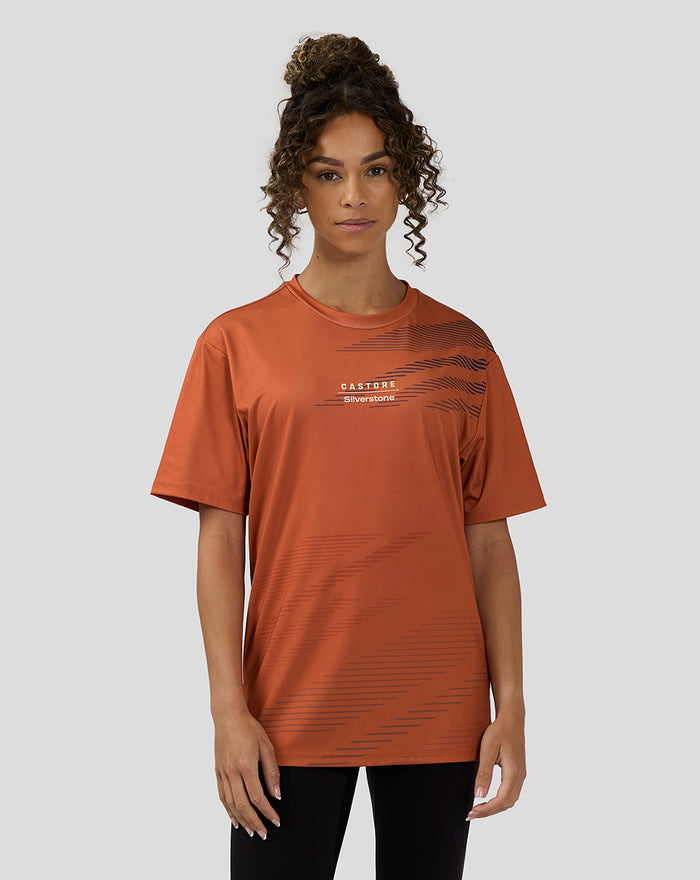 Orange rust short sleeve T shirt with graphic lines and Castore Silverstone branding.