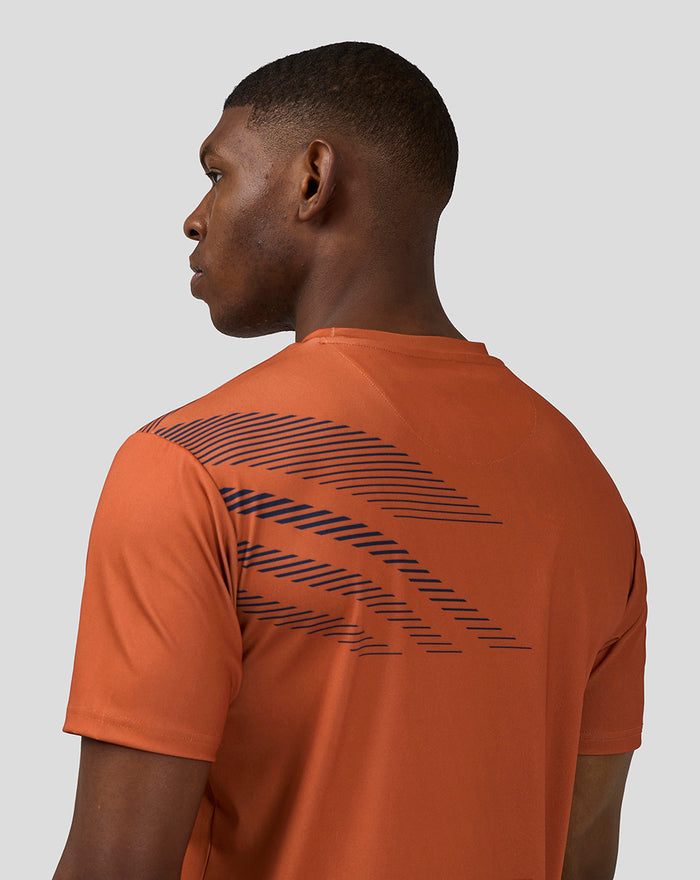 Back view of orange rust unisex Silverstone sublimated Short Sleeve T-Shirt with navy diagonal stripe print across the back.