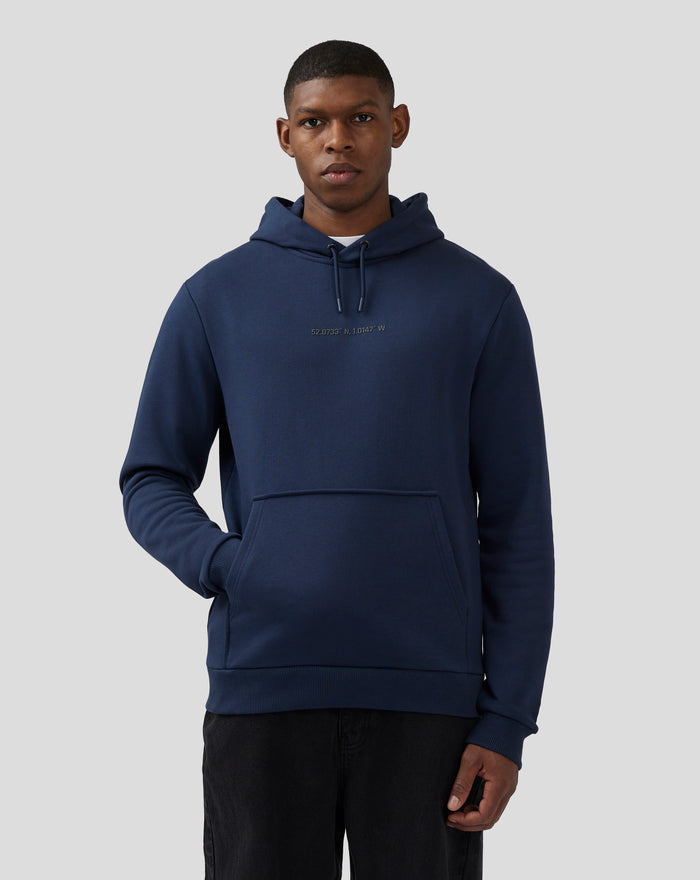 Back view of a man in a navy hoodie with a large back graphic