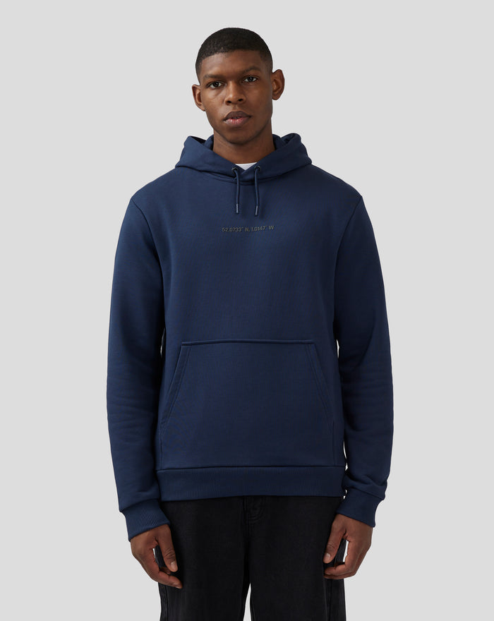 Close-up of navy hoodie chest area showing coordinates print.