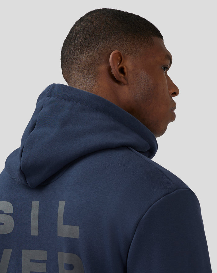 Profile view of a model wearing a navy Silverstone Core Graphic Hoodie with hood up