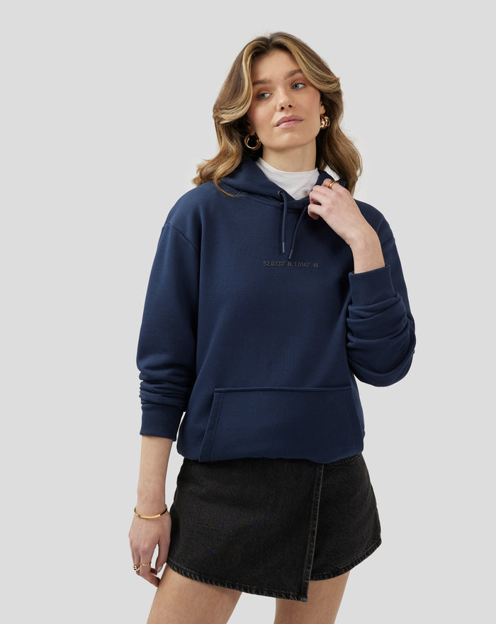 Front view of a model wearing a navy Silverstone Core Graphic Hoodie with kangaroo pocket and drawstring hood