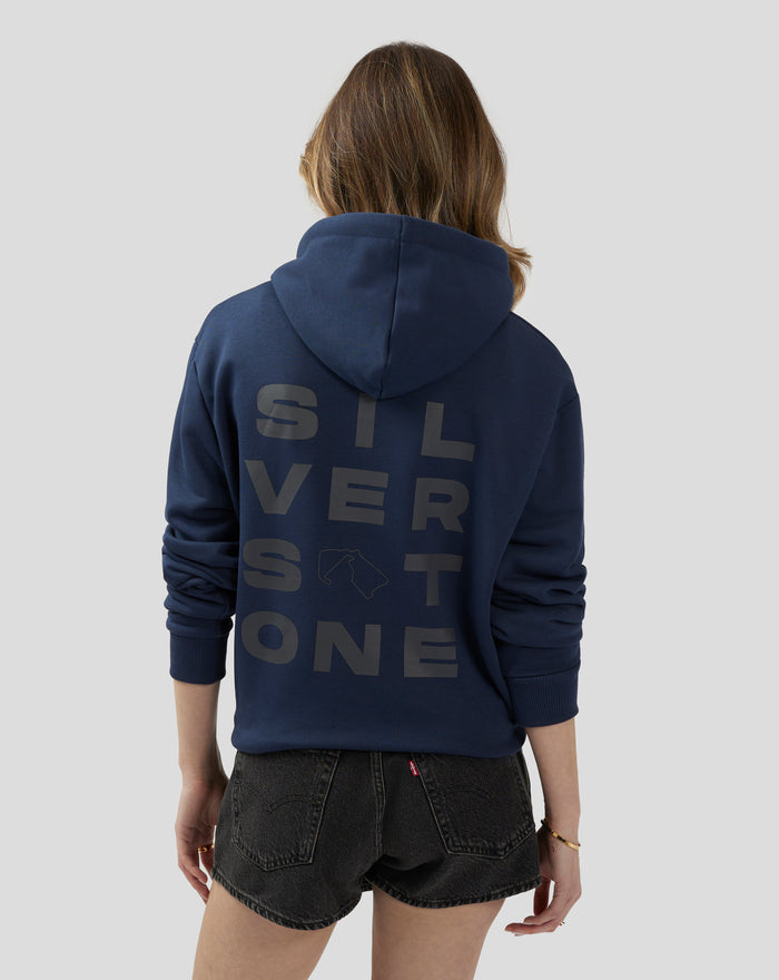 Back view of a model wearing a navy Silverstone Core Graphic Hoodie with a large back graphic.