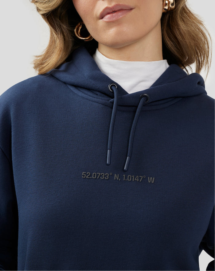 Close up of a navy hoodie with bold graphic text across the chest area