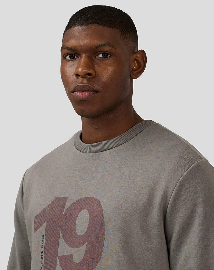 Close up of a male model wearing the charcoal grey Silverstone Core Sweatshirt with a large 1948 graphic.