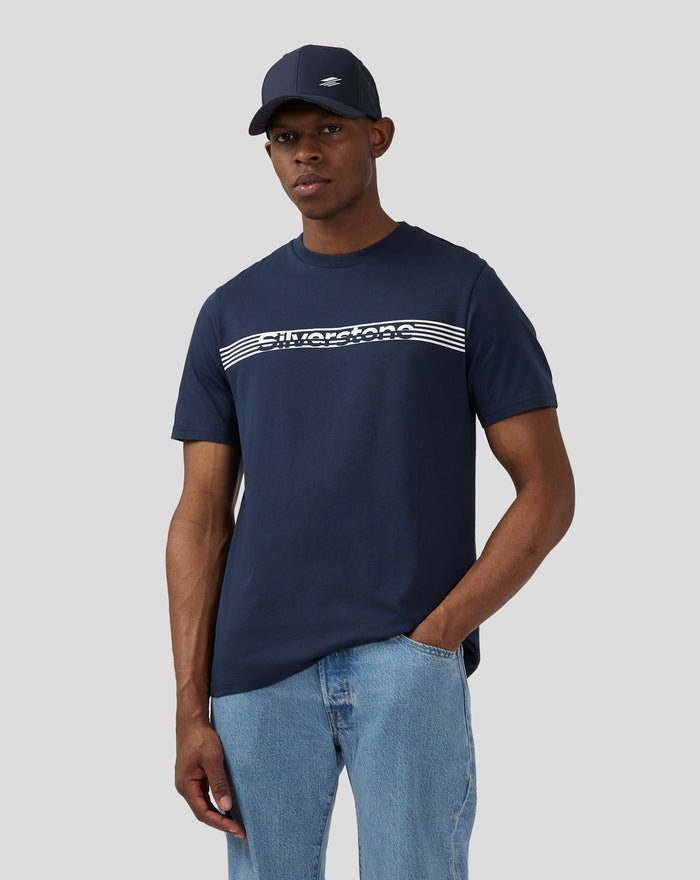Male model wearing navy Silverstone Core T Shirt with white chest graphic and cap