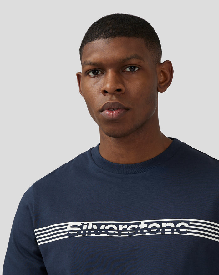 Close up of a man wearing navy Silverstone Core T Shirt with bold white chest graphic