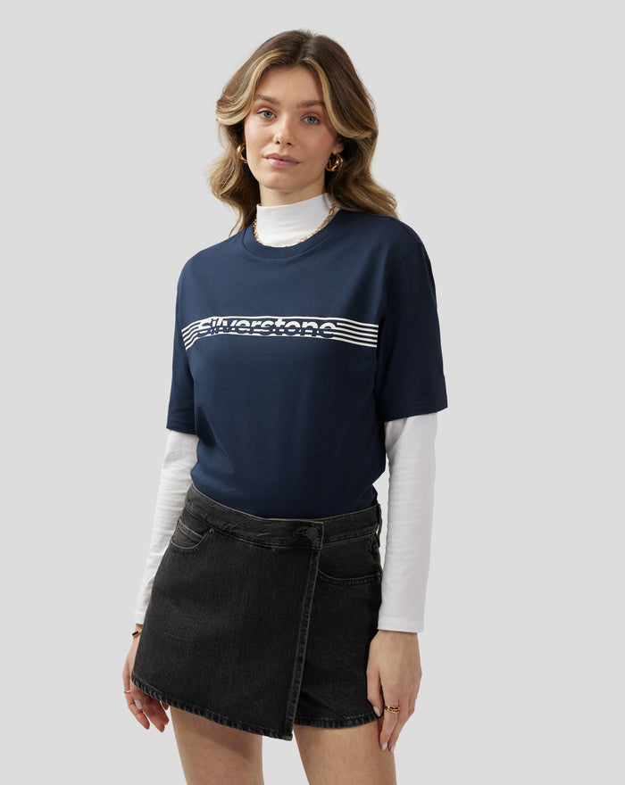 Portrait of a woman wearing a navy Silverstone Core T-Shirt with a white graphic logo across the chest.