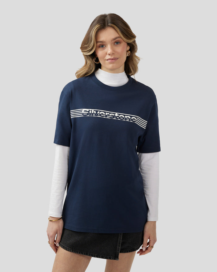 Close up of model wearing navy Silverstone Core T Shirt over a white layer, with gold hoop earrings.