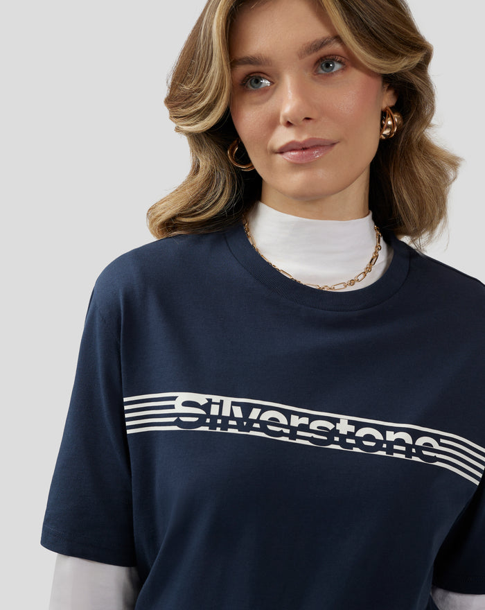 Detail shot of navy T shirt showing the white chest graphic and curved lines across the chest.