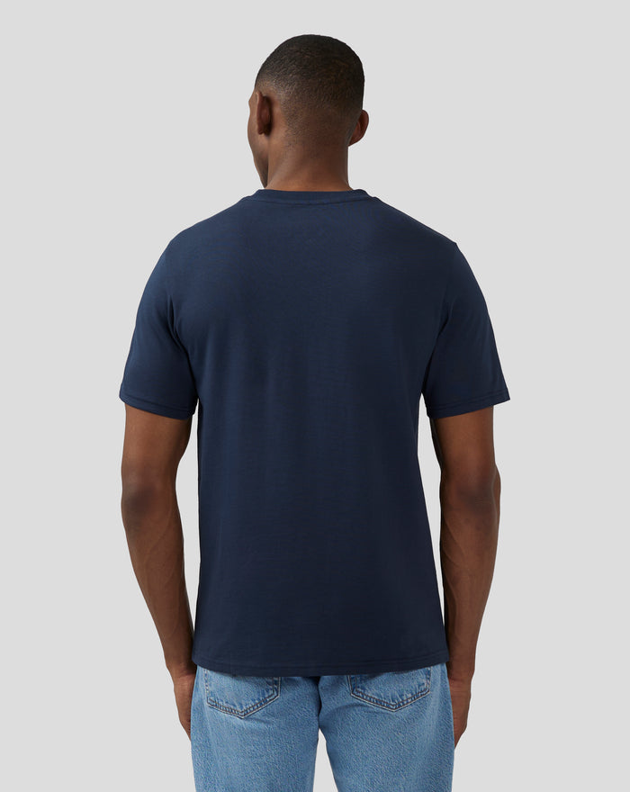 Back view of model in navy Silverstone Core 1948 T Shirt with no visible print