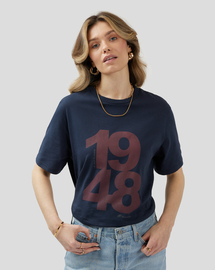 Casual shot of a woman in a Black Iris Silverstone Core 1948 T-Shirt showing the oversized two-tone front print on navy fabric
